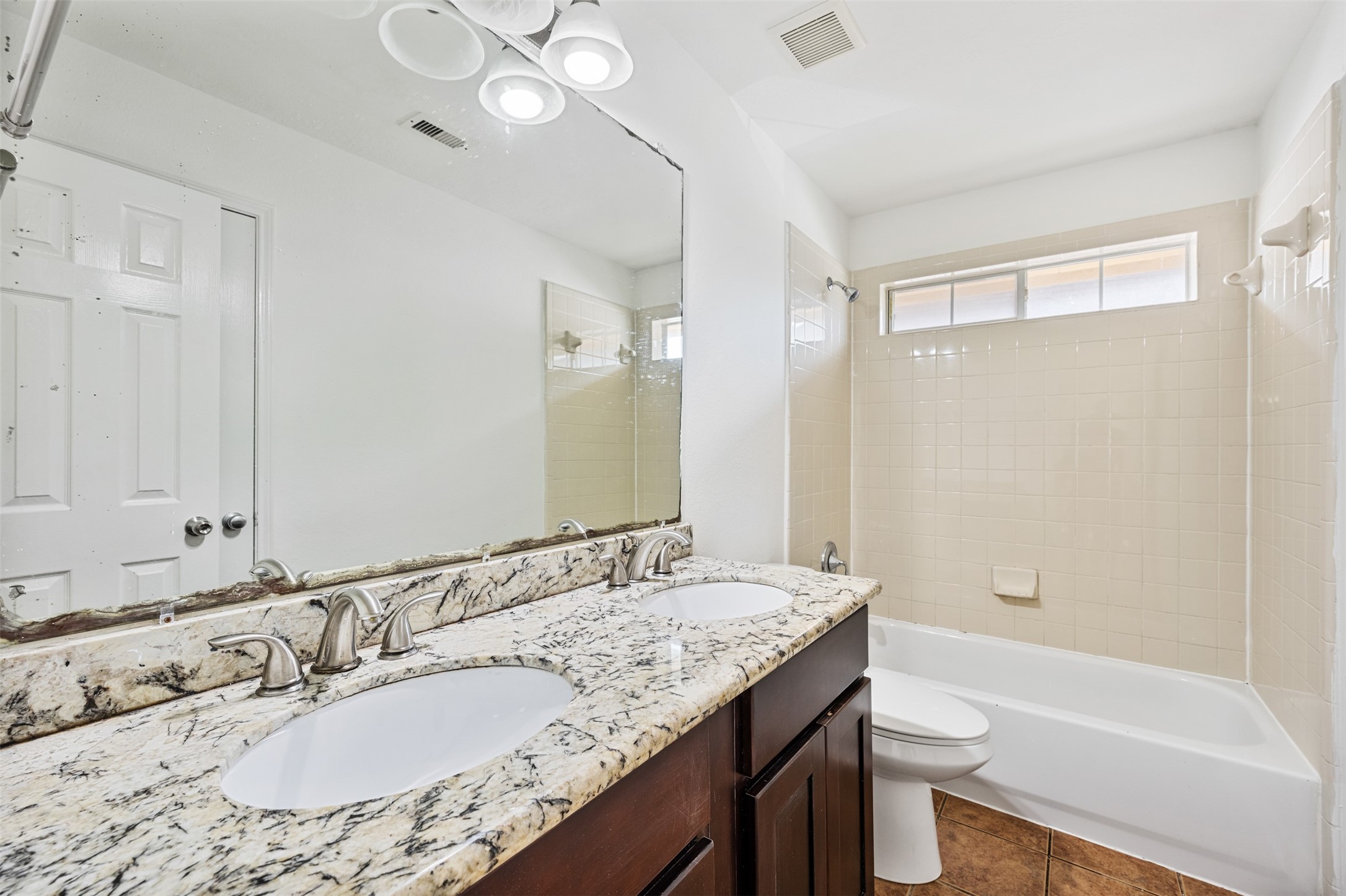 6806 Stableton Lane Houston, TX 77049 - Photo 7 of 50 a bathroom with a granite countertop sink a toilet a mirror and shower