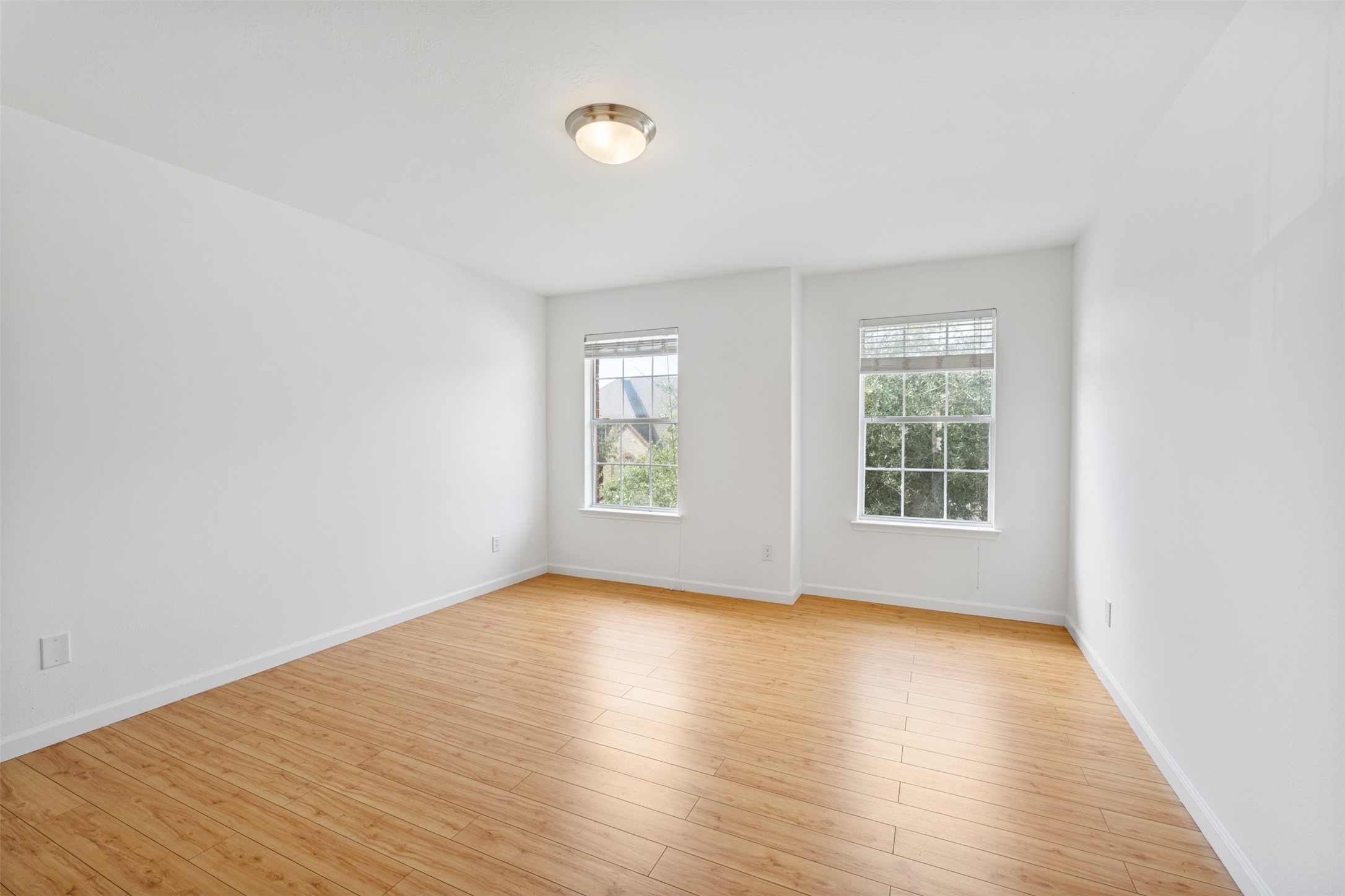 6806 Stableton Lane Houston, TX 77049 - Photo 8 of 50 an empty room with wooden floor and windows
