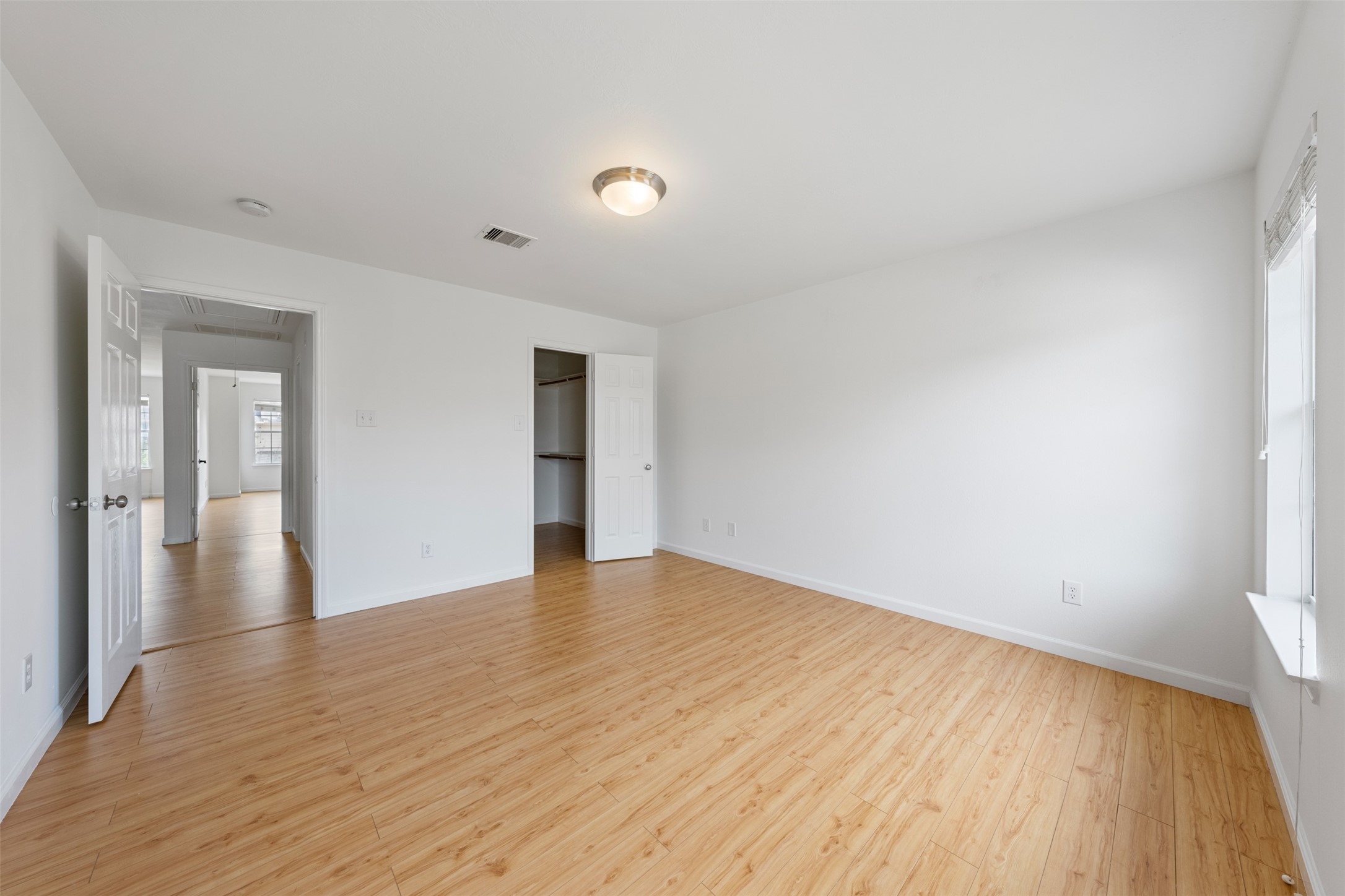 6806 Stableton Lane Houston, TX 77049 - Photo 9 of 50 a view of an empty room with wooden floor and a window