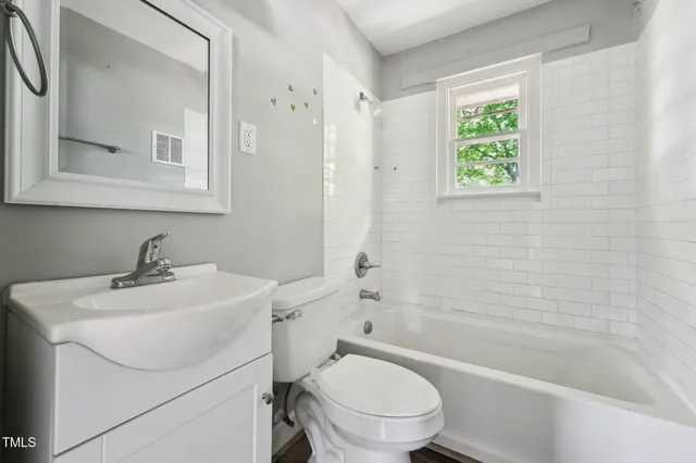 a view of an empty room and wooden floor