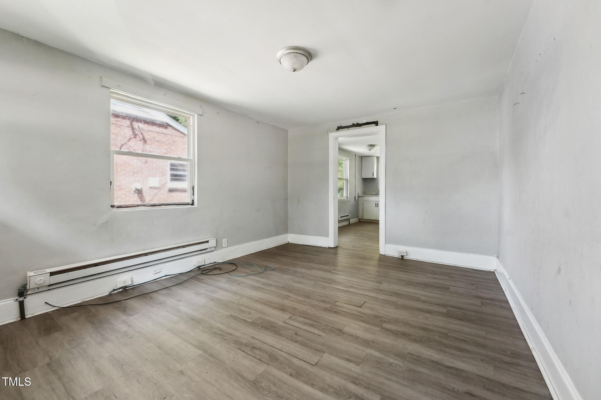 6316 Ward Boulevard Wilson, NC 27893 - Photo 19 of 36 an empty room with wooden floor and windows