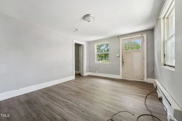 a view of an empty room and wooden floor
