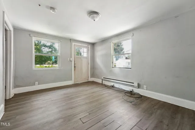 wooden floor in an empty room with a window