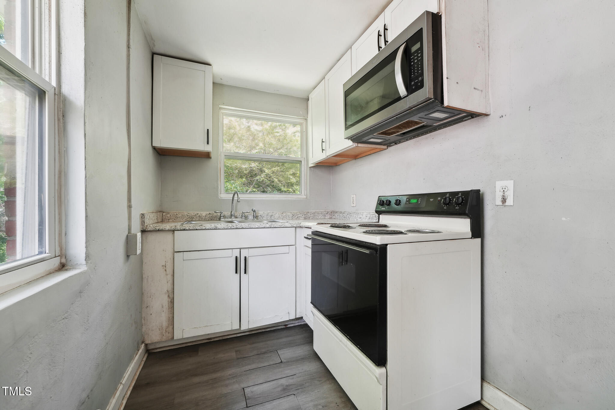 6316 Ward Boulevard Wilson, NC 27893 - Photo 23 of 36 a kitchen with stainless steel appliances granite countertop a stove a microwave and a sink