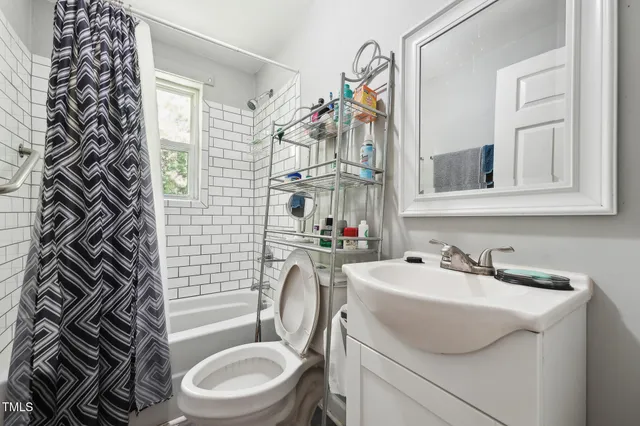 a bedroom with furniture and a window