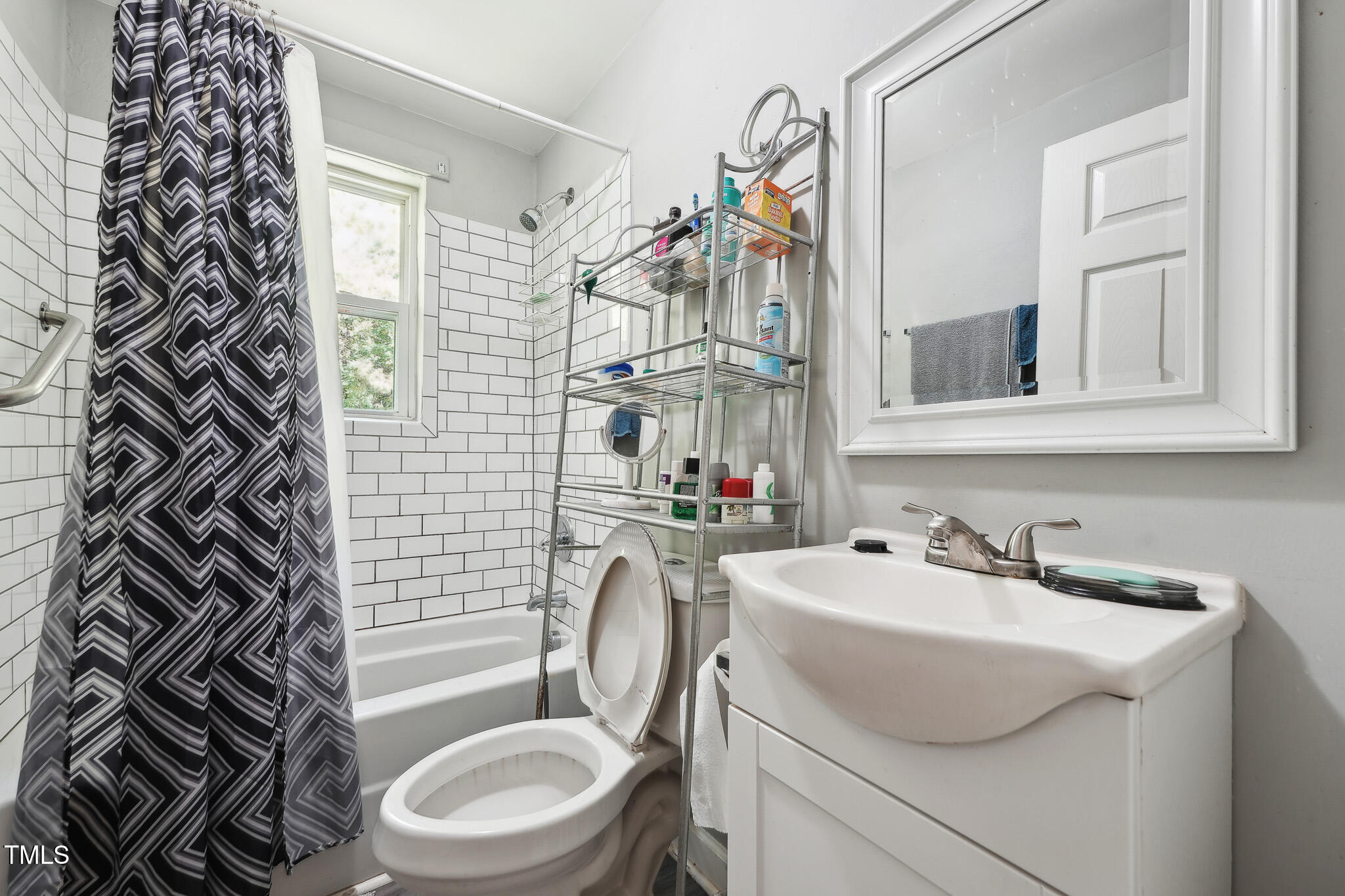 6316 Ward Boulevard Wilson, NC 27893 - Photo 30 of 36 a bathroom with a sink a toilet and mirror
