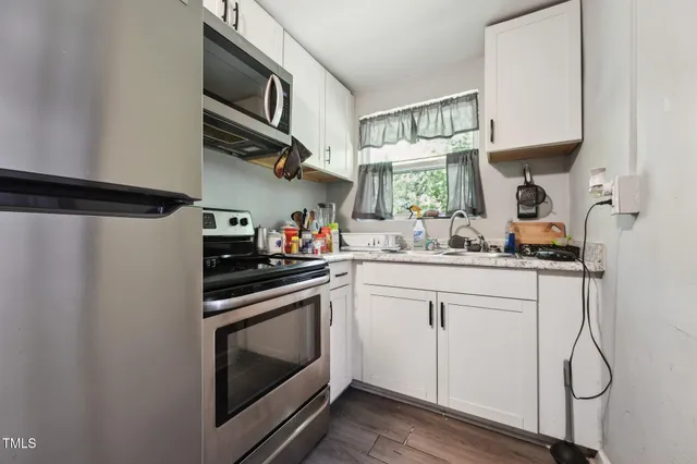 a kitchen with a sink appliances and cabinets