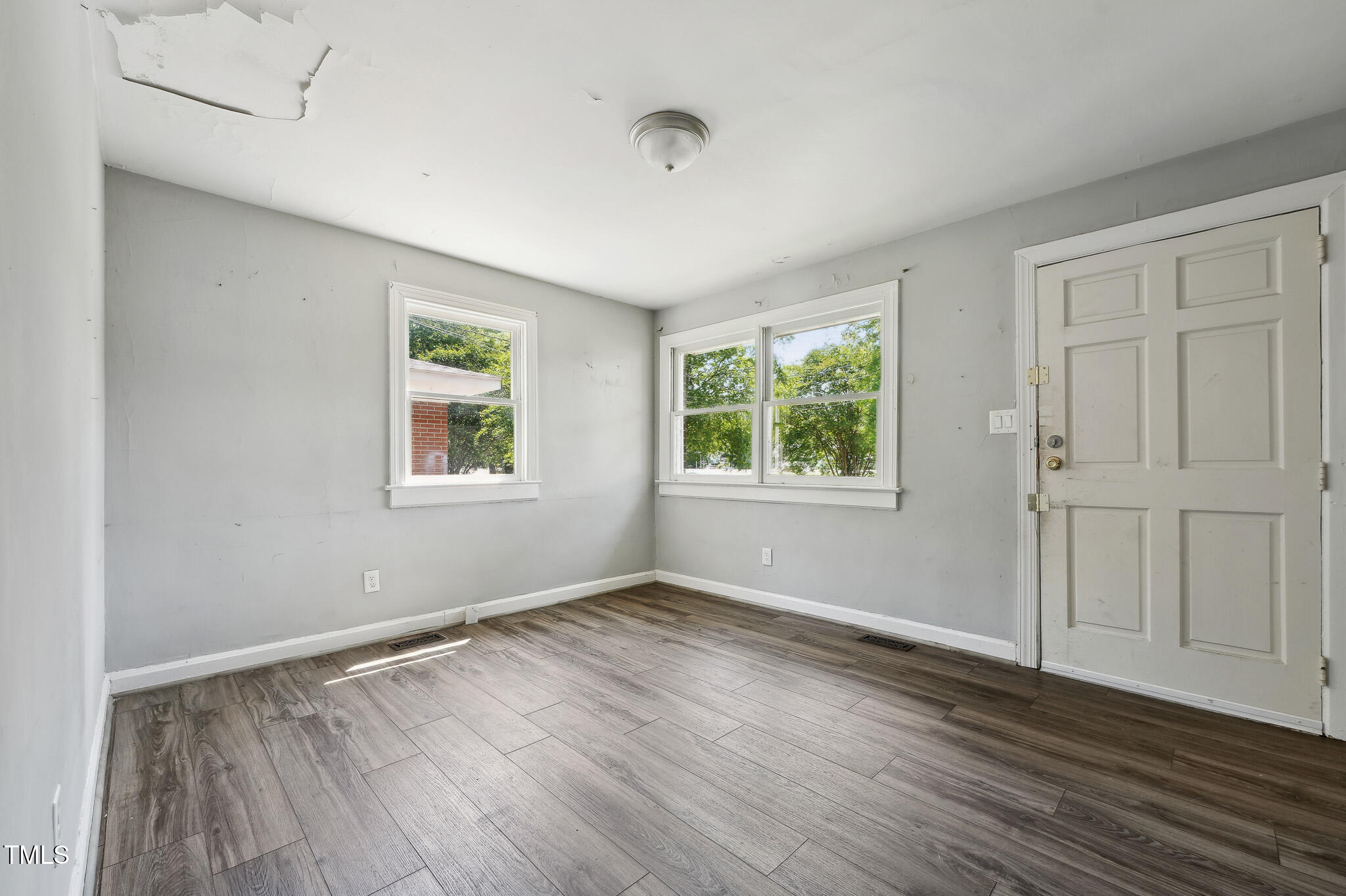 6316 Ward Boulevard Wilson, NC 27893 - Photo 3 of 36 an empty room with wooden floor and windows