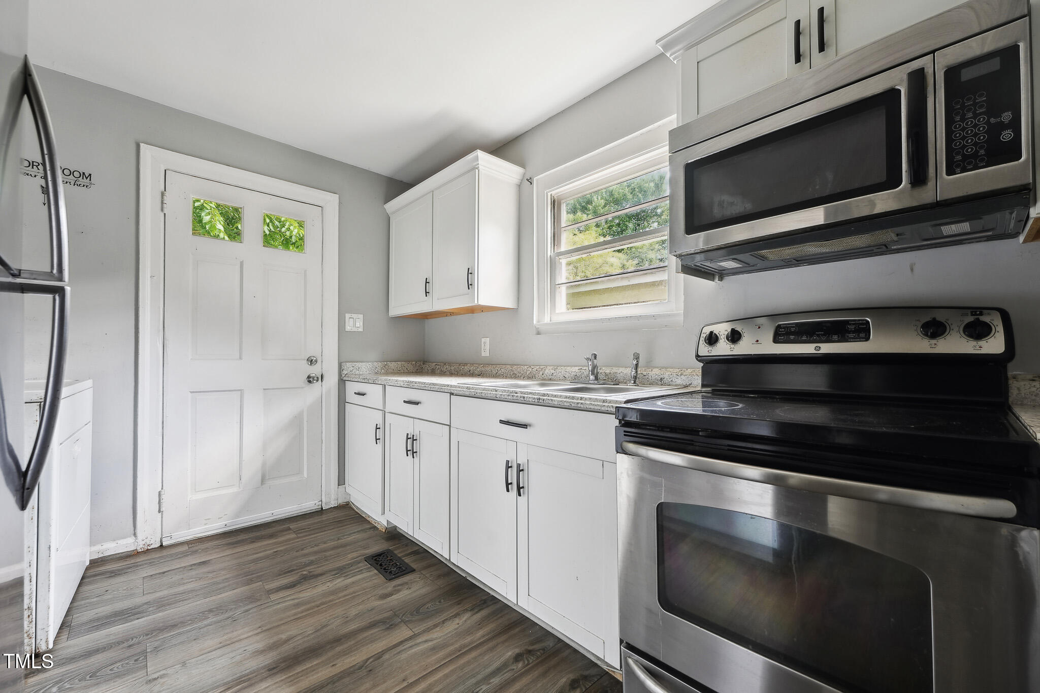 6316 Ward Boulevard Wilson, NC 27893 - Photo 6 of 36 a kitchen with granite countertop cabinets stainless steel appliances and a window