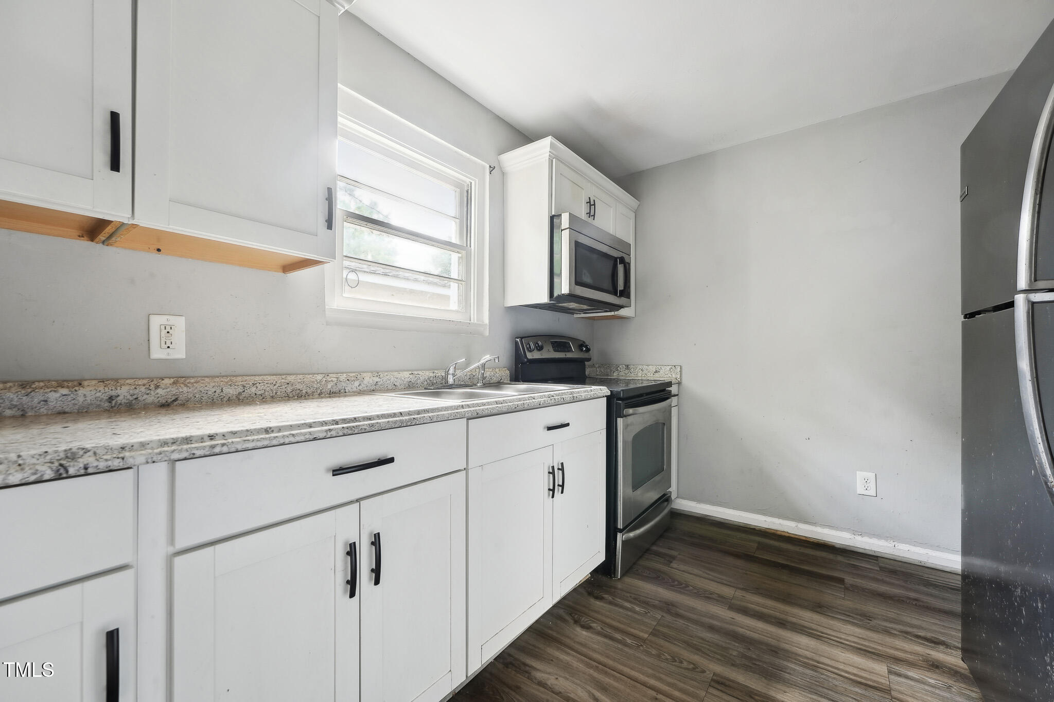 6316 Ward Boulevard Wilson, NC 27893 - Photo 7 of 36 a kitchen with granite countertop cabinets stainless steel appliances a sink and a window