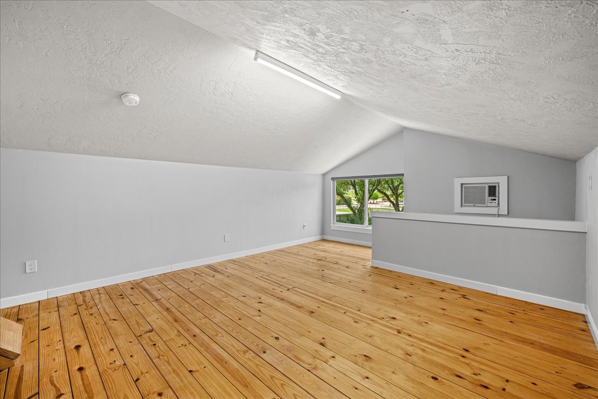 1502 Reimer Street Brenham, TX 77833 - Photo 24 of 30 a view of an empty room with wooden floor and a window