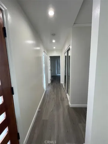 a view of hallway with wooden floor