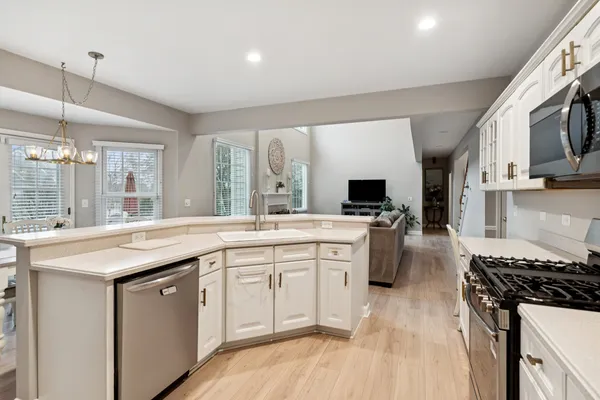 a kitchen with stainless steel appliances a sink dishwasher stove refrigerator and microwave