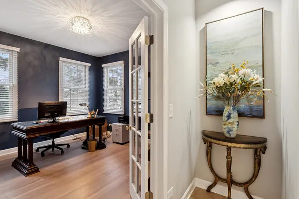 a view of a workspace with furniture and a window