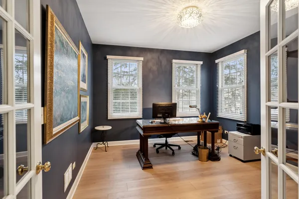 a view of a workspace with furniture and a window