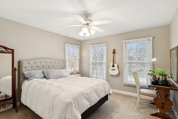 a bedroom with a large bed and a chandelier