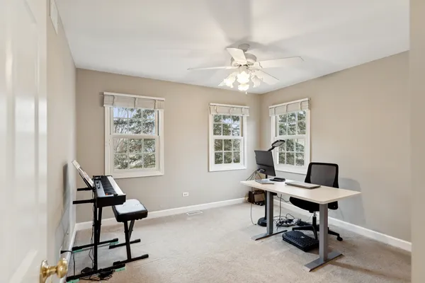 a workspace with wooden floor and a window