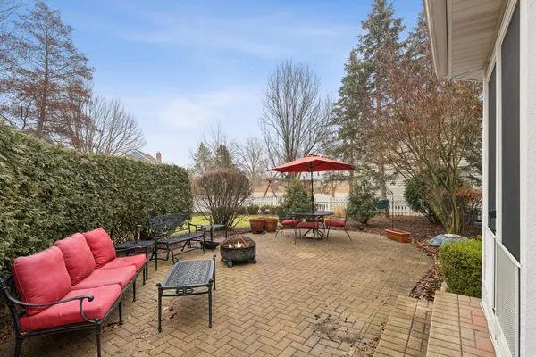 a backyard of a house with table and chairs