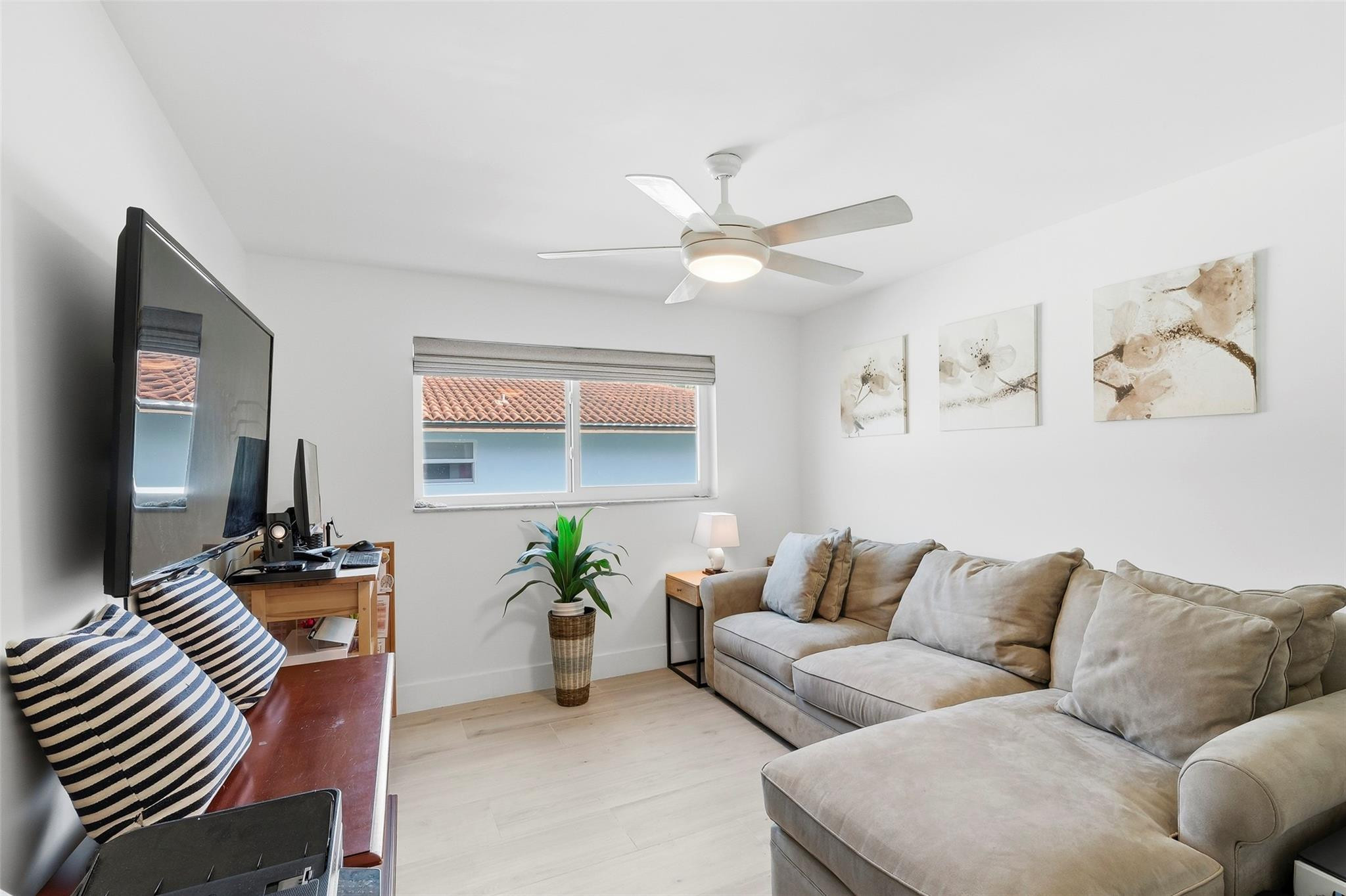 1450 North Riverside Drive, Unit 201 Pompano Beach, FL 33062 - Photo 14 of 30 a living room with furniture and a chandelier