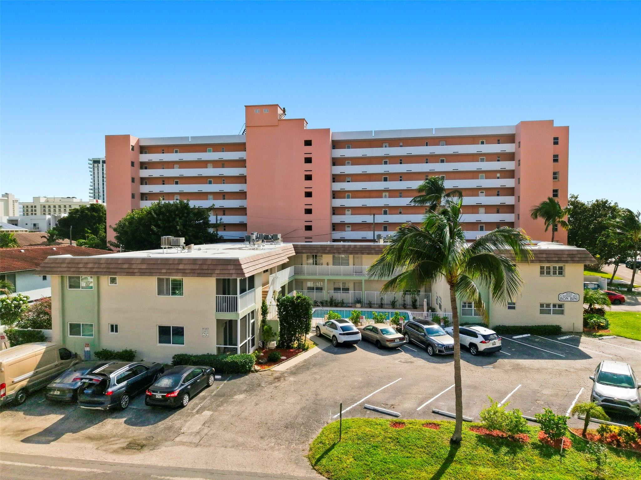 1450 North Riverside Drive, Unit 201 Pompano Beach, FL 33062 - Photo 28 of 30 a front view of a building with glass windows and cars parked