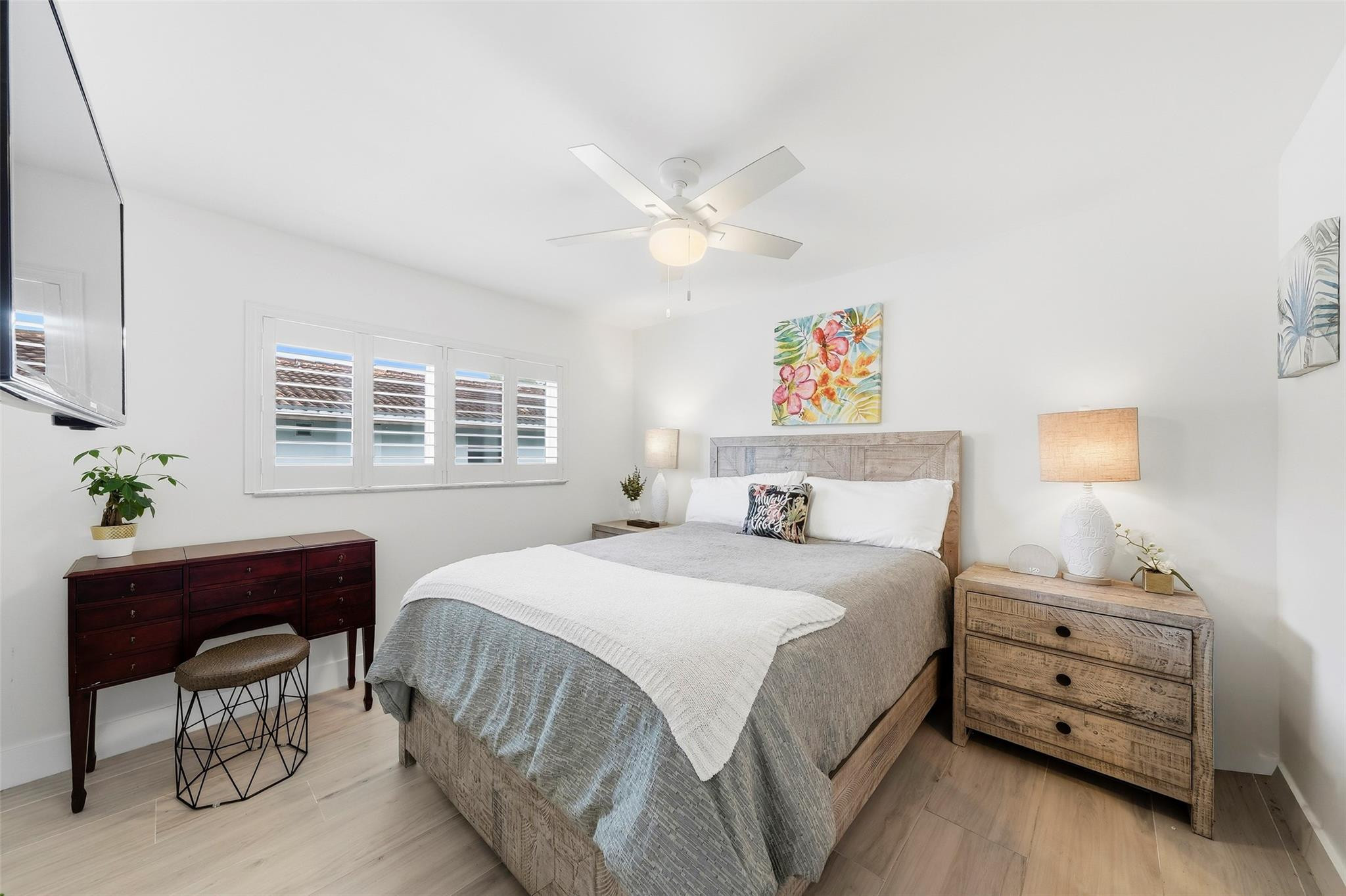 1450 North Riverside Drive, Unit 201 Pompano Beach, FL 33062 - Photo 8 of 30 a bedroom with a bed and a chandelier