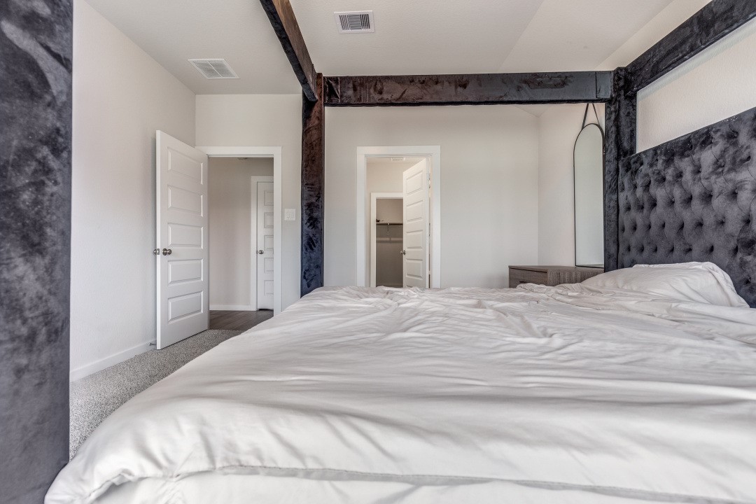 1318 Cascade Hls Drive Rosharon, TX 77583 - Photo 14 of 25 a bedroom with a bed and a mirror