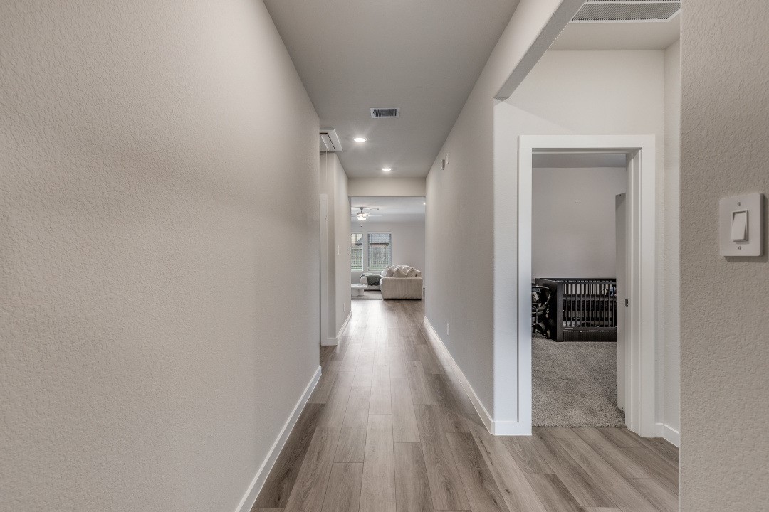 1318 Cascade Hls Drive Rosharon, TX 77583 - Photo 5 of 25 a view of a hallway with wooden floor and a bathroom