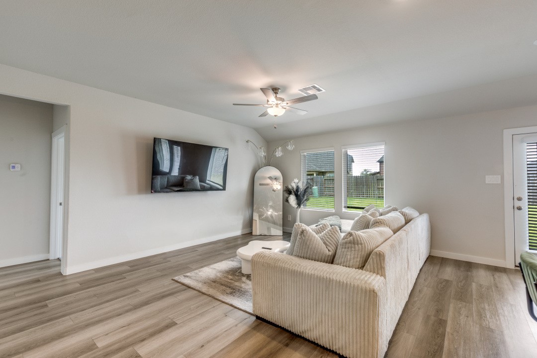 1318 Cascade Hls Drive Rosharon, TX 77583 - Photo 7 of 25 a living room with furniture and a flat screen tv