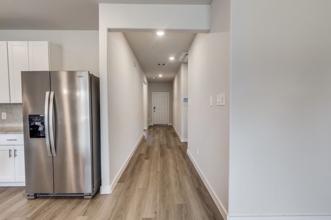 1318 Cascade Hls Drive Rosharon, TX 77583 - Photo 9 of 25 a view of a hallway with wooden floor