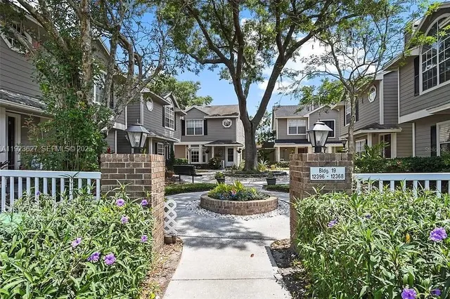 a view of a house with sitting area and garden