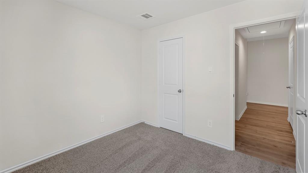 1969 Freeman Street Tyler, TX 75704 - Photo 26 of 30 Interior space featuring light gray carpeting, white baseboards, and a solid white interior door with a silver knob