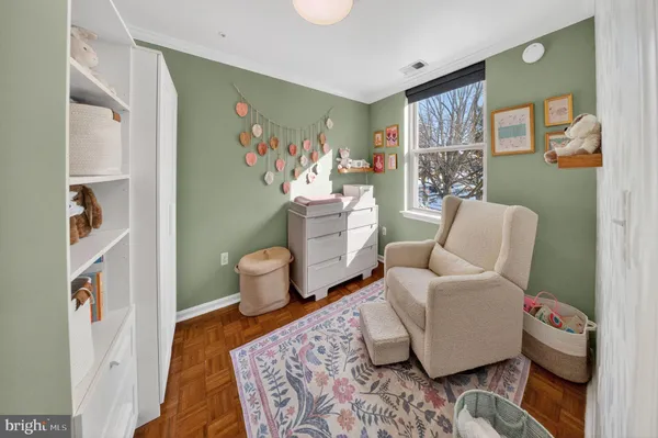 a living room with furniture and a painting on the wall