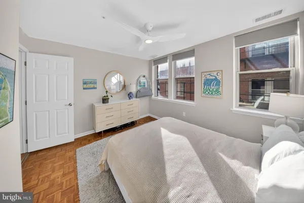 a bedroom with a bed and a large window