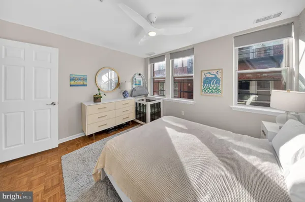 a bedroom with a bed next to a window