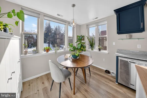 a dining room with furniture a window and a chandelier