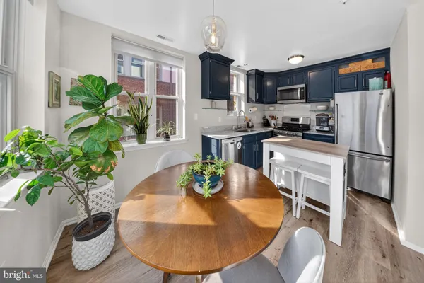 a view of a kitchen with furniture and a potted plant