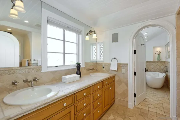 a spacious bathroom with a granite countertop sink and a mirror
