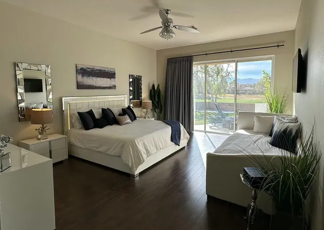 a bedroom with a bed and glass window