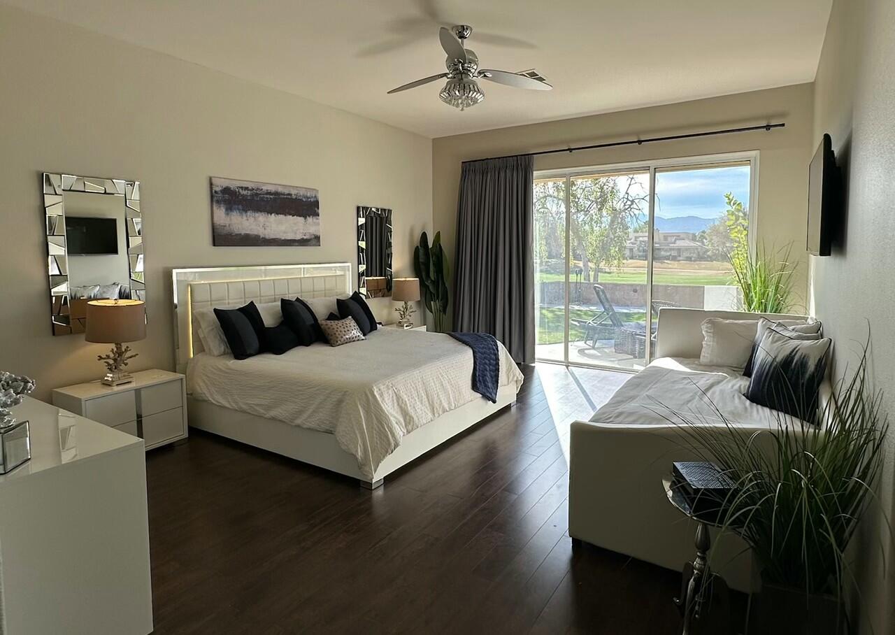 65 La Costa Drive Rancho Mirage, CA 92270 - Photo 14 of 22 a bedroom with a bed and glass window