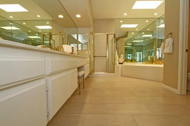 a bathroom with a glass shower door and a sink