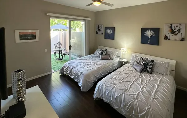 a bedroom with two beds and a window