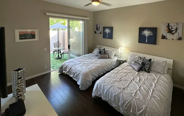 a bedroom with two beds and a window