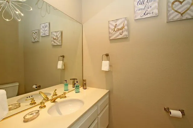 a bathroom with a sink mirror and vanity