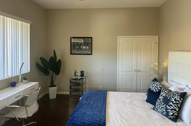 a bedroom with a bed and a potted plant