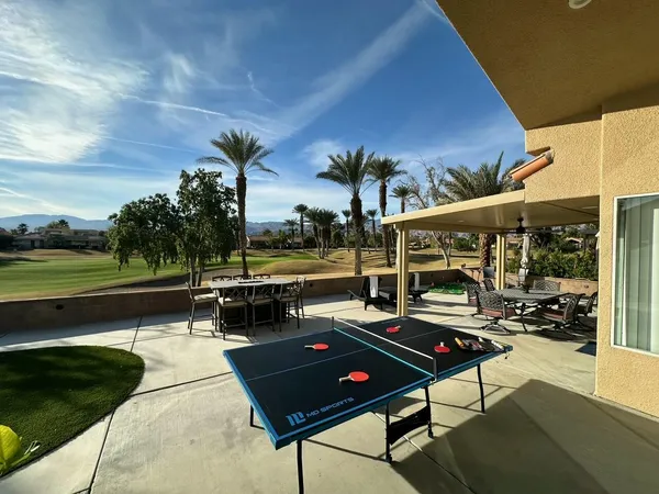 a view of a patio with chairs and a table