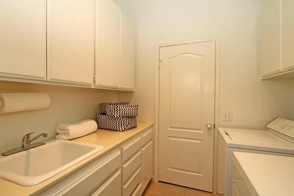 a bathroom with a sink and washing machine