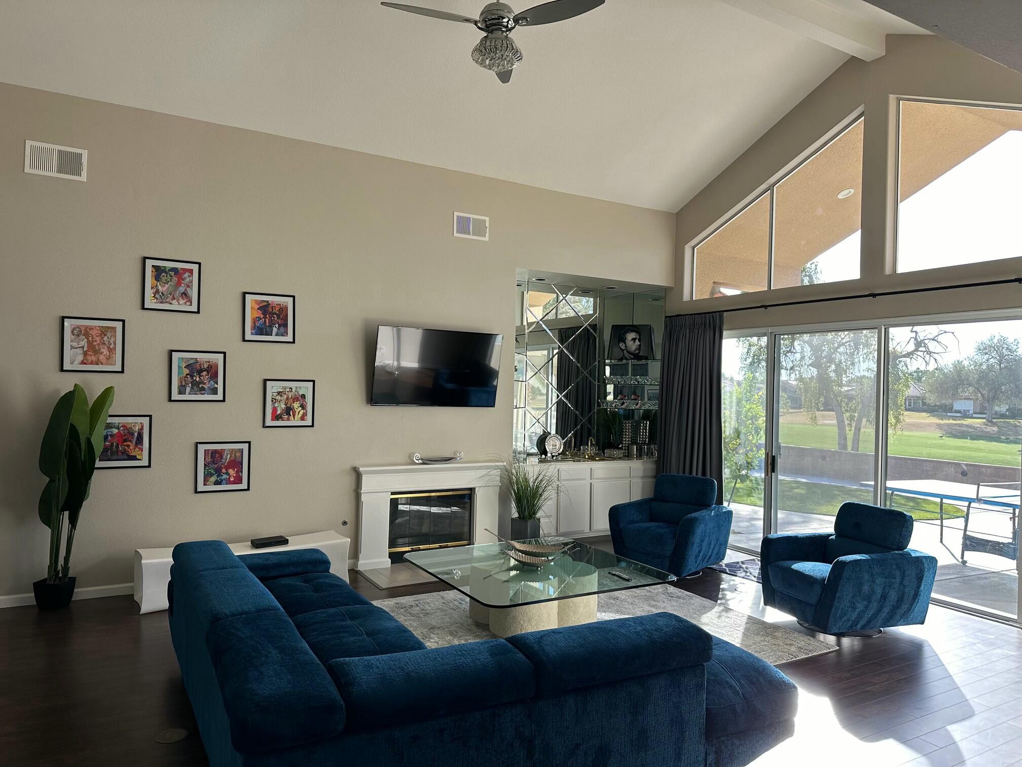 65 La Costa Drive Rancho Mirage, CA 92270 - Photo 9 of 22 a living room with furniture a flat screen tv and a large window