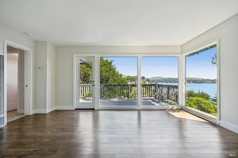 a view of a balcony with wooden fence and floor