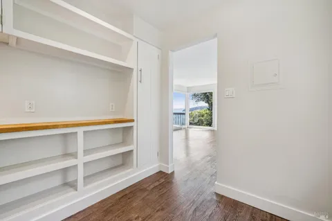 an empty room with windows and closet