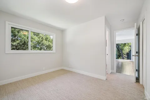 an empty room with windows and closet